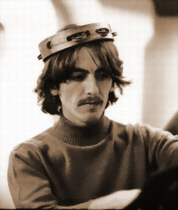 george with a tambourine on his head